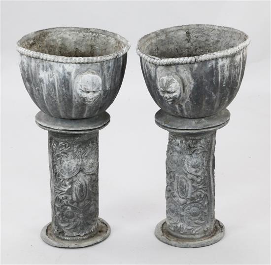 A pair of 17th century style lead garden urns, Diam. 1ft 1in. H.2ft